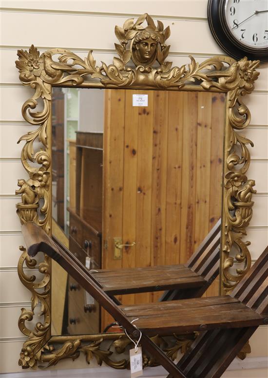 A gilt painted carved wood mirror W.69cm